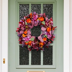 Autumn Thanksgiving wreath with purple dahlia and hydrangea on a vintage door