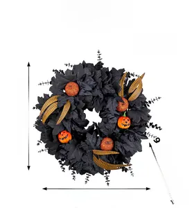 Detail view of Halloween wreath with black maple leaves and orange pumpkin dimensions