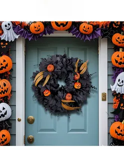 Detail of Halloween wreath featuring black maple leaves and pumpkin lights on a door