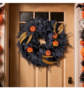 Detail of Halloween wreath with black maple leaves, glitter pumpkins and spooky lanterns