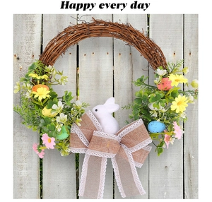 Detail of Easter wreath with burlap lace bow, foam bunny, and colorful speckled eggs