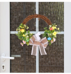 Close-up of Easter wreath with foam eggs and a white bunny on a rustic white door
