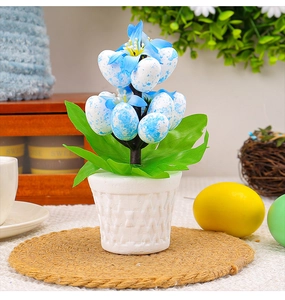 Detail of Easter artificial plant with blue speckled foam eggs in a woven texture pot