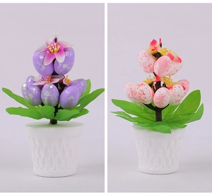 Detail of Easter egg potted plants with speckled foam eggs and geometric white pots
