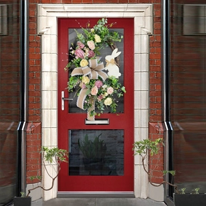 Easter wreath with flowers, burlap bow and bunny silhouette on a red front door