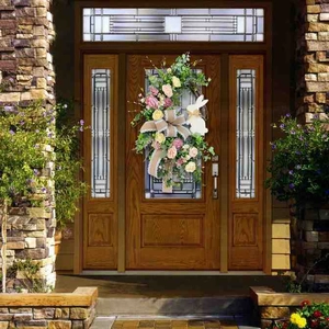 Detailed view of an Easter wreath with a white bunny and burlap bow on a wooden door