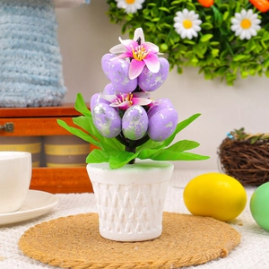 Easter decorative artificial plant with purple speckled eggs and flowers in a white pot