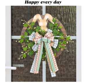 Detail of Easter door wreath with bunny ears, faux greenery, and plaid burlap ribbons