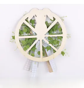 Detail of wooden bunny wreath with green ivy and rustic ribbons on white background