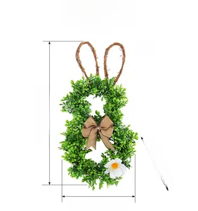 Easter bunny wreath detail with green faux leaves, burlap bow, and daisy accents