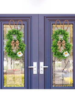 Easter rabbit wreath with green foliage and linen bow on purple double doors