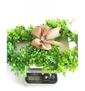 Detailed weight display of an artificial green leaf Easter wreath on a scale, approx 247g