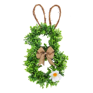 Easter bunny wreath made of artificial greenery with dry vine ears and burlap bow