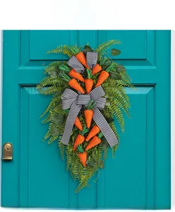 Detail of Easter door swag with faux carrots, fern leaves, and black white striped bow