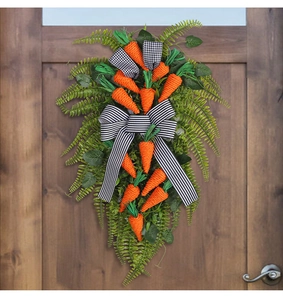 Close-up of Easter carrot door swag with rustic orange twine carrots and striped bow