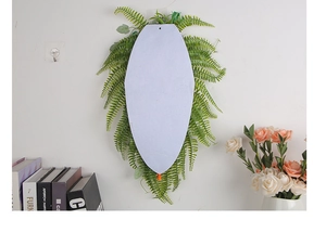 Detail of white felt backing with realistic green fern foliage for wall decoration