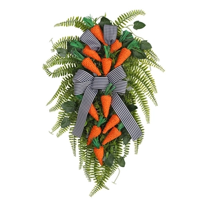 Easter carrot swag wreath with greenery and black and white striped bow for home decor