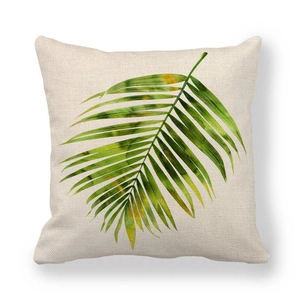 Macro detail of high-quality linen texture and green watercolor leaf print on pillow cover