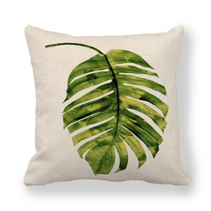 Close-up of the natural linen texture and detailed green tropical leaf print on cushion