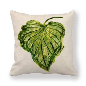 Close-up of green leaf watercolor print on thick linen texture decorative pillow cover