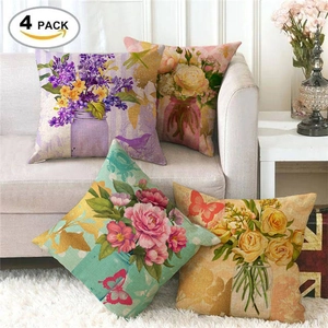 Set of four linen pillowcases with realistic floral and butterfly patterns on a sofa