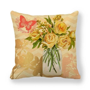 Close-up of linen pillowcase featuring vintage yellow peony flower in glass jar and butterfly
