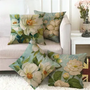 Close-up of four linen camellia pillow covers with vintage artistic floral patterns