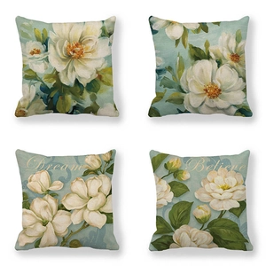 Set of four light blue floral linen pillow covers featuring Dream and Believe text prints