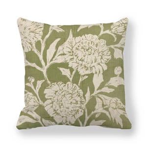 Close-up of linen cushion cover showing detailed white flower print and textured fabric