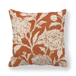 Linen pillowcase with hand-painted white floral pattern on a warm brick red background