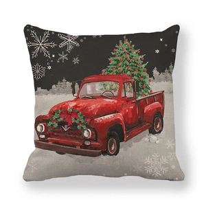 Close-up of linen texture on Christmas pillow cover with vintage red truck print