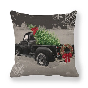 Close-up of vintage truck and Christmas tree design on textured linen pillowcase