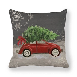 Detail of Christmas pillow cover with red vintage car and Xmas tree on linen texture