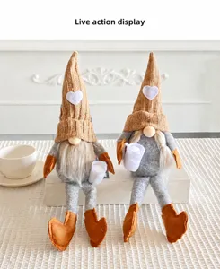 Detail of plush gnome dolls with knitted heart hats and soft felt bodies in home setting