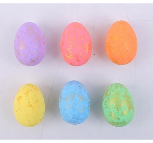 Close-up of six colorful matte Easter eggs with gold foil speckles on white background