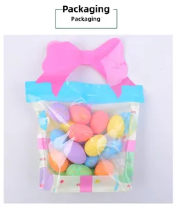 Colorful Easter foam eggs with gold speckles in a transparent gift bag with pink bow