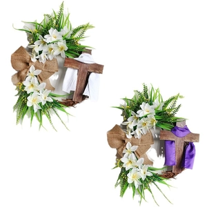Easter wreath with wooden cross, white lilies, and green leaves for door decoration