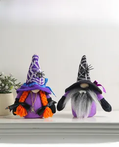Detail view of Halloween gnome plushies with spider pendant and vampire fangs decor