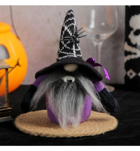 Detail of Halloween gnome doll with vampire fangs and spider web hat for table decor