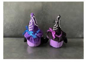 Detail view showing the back texture of Halloween gnome plush dolls with purple hats