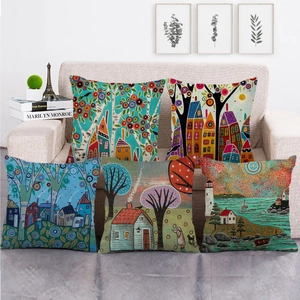 Set of 5 linen pillow covers with artistic folk style paintings on a beige sofa