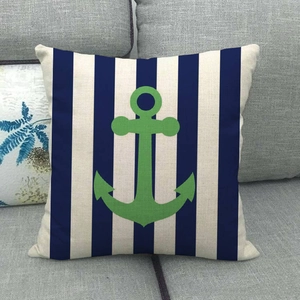 Detail of nautical linen pillow cover featuring a green anchor on navy and white stripes