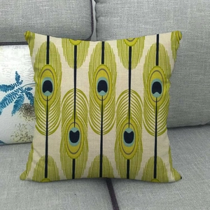 Detailed texture of linen throw pillow cover with green and blue peacock feather pattern