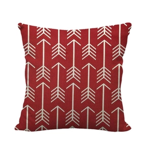 Red linen cushion cover featuring geometric white arrow patterns on a white background