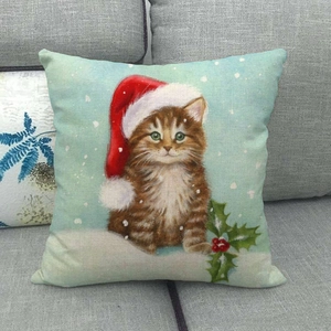 Detailed close-up of a Christmas linen pillow cover featuring a festive cat on a gray sofa