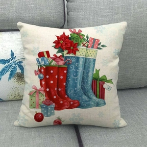 Close-up of linen pillowcase featuring colorful Christmas stockings and gift patterns