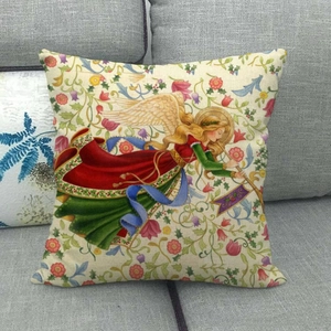 Detail of linen cushion cover featuring a vintage angel illustration on a gray sofa
