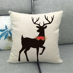Linen Christmas reindeer pillow cover in beige on a sofa, minimalist Nordic holiday decor