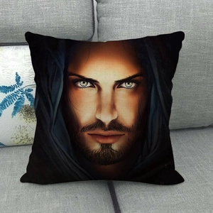 Linen square pillowcase with artistic hooded man portrait on a grey fabric sofa