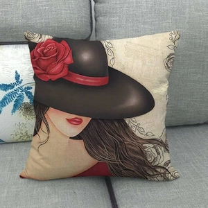 Detail of artistic girl with rose hat print on linen square cushion cover on sofa